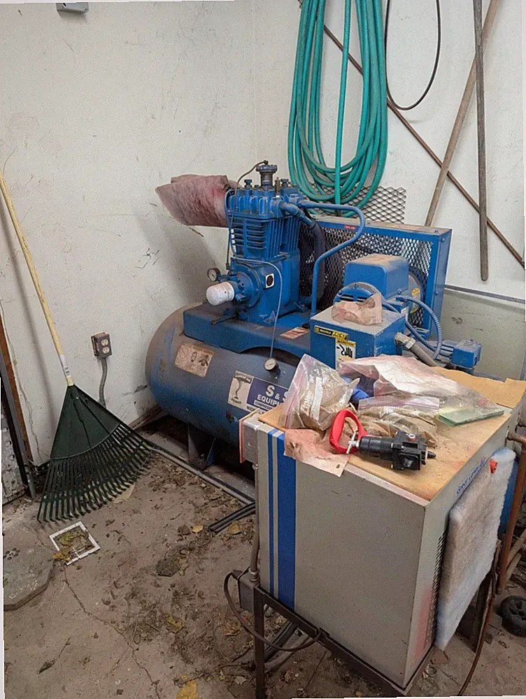 Reciprocating air compressor, designed for industrial applications.